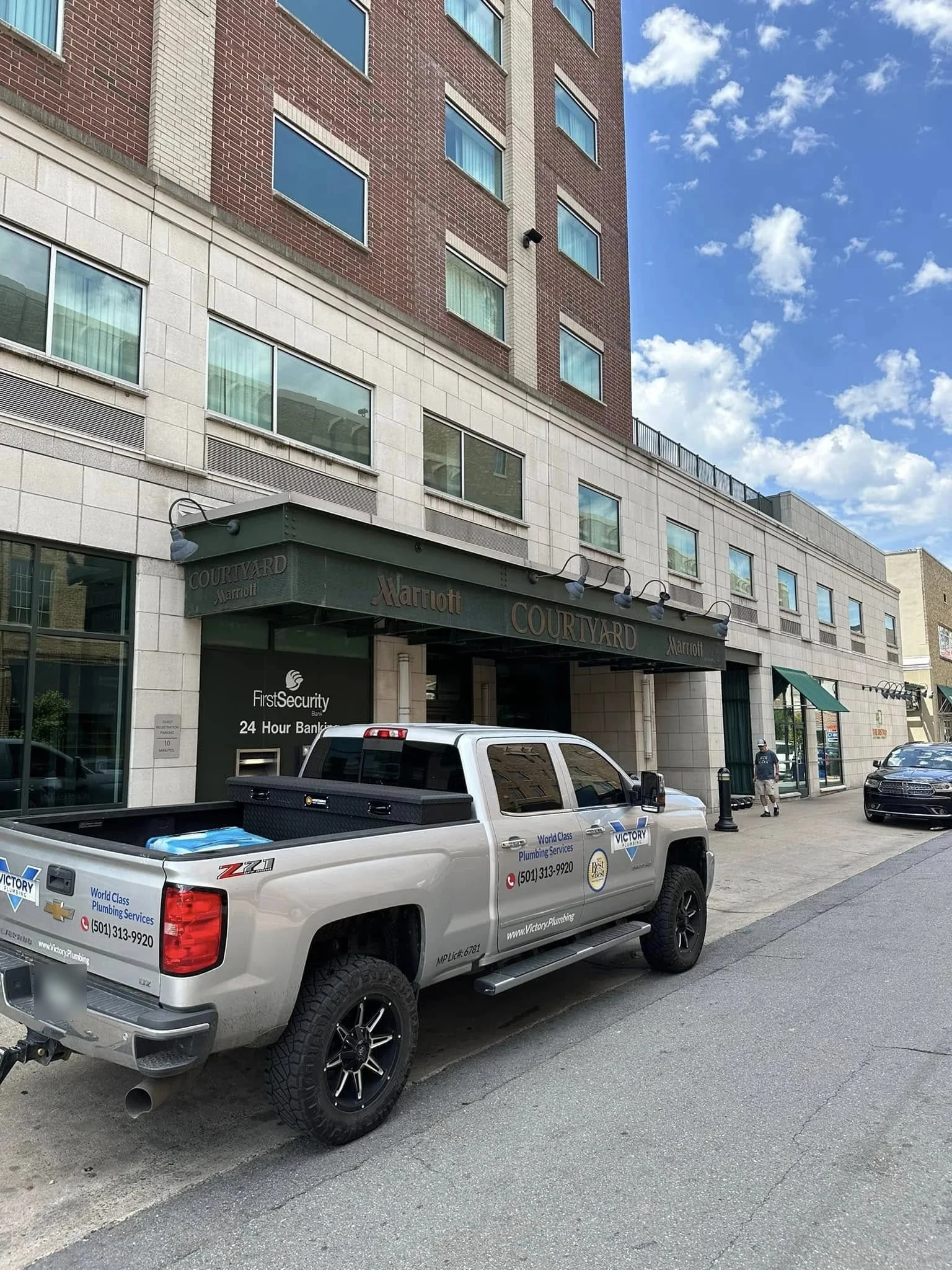 A Victory Plumbing truck on a commercial job downtown