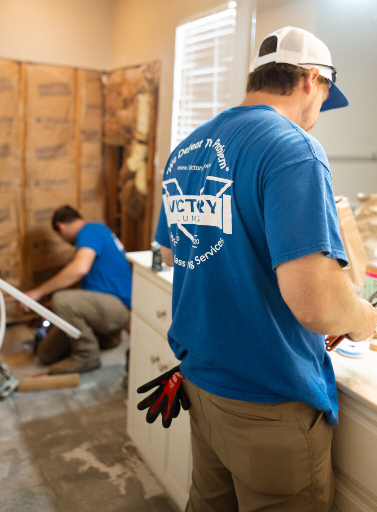 Two plumbers working on an installation.