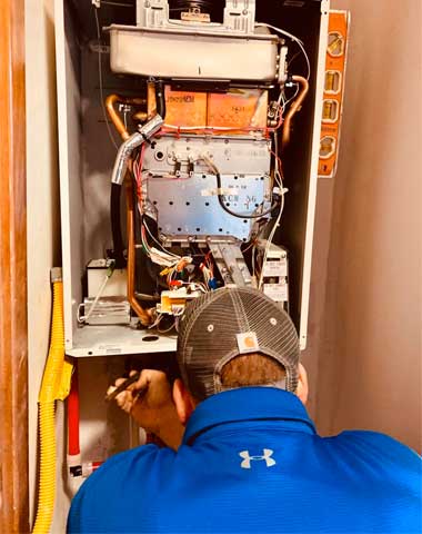 Travis working on a tankless water heater